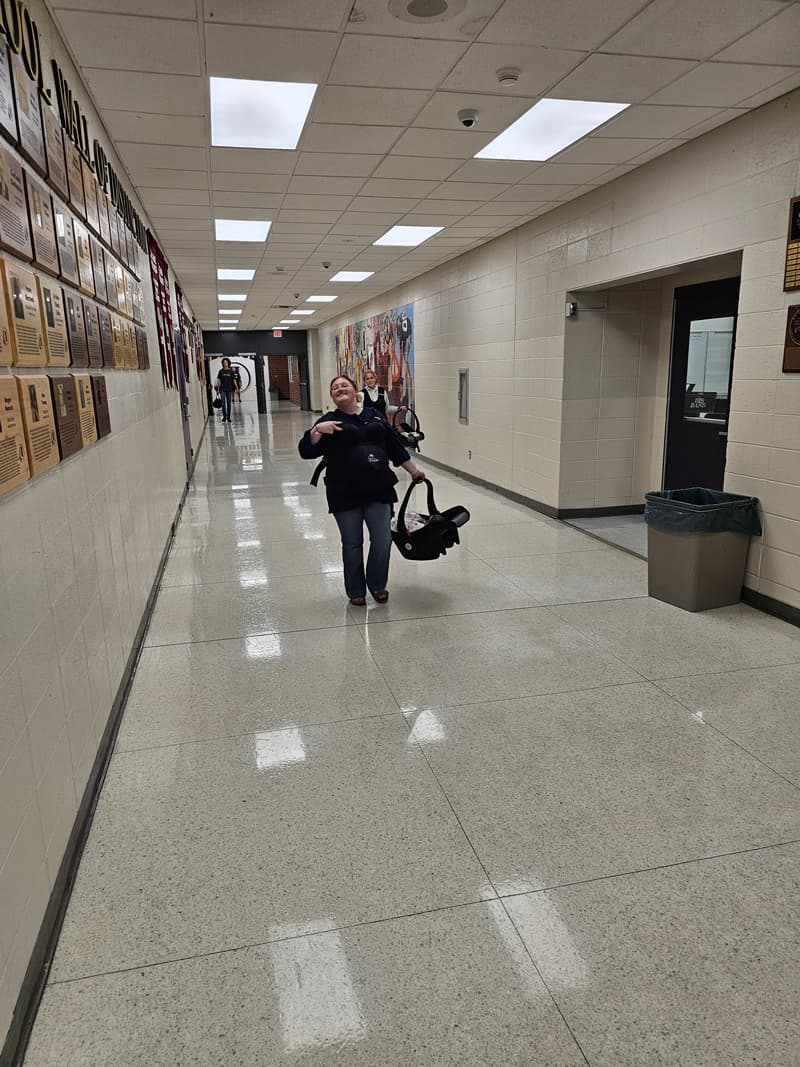 20240925_140535-min Students carrying babydoll carseats