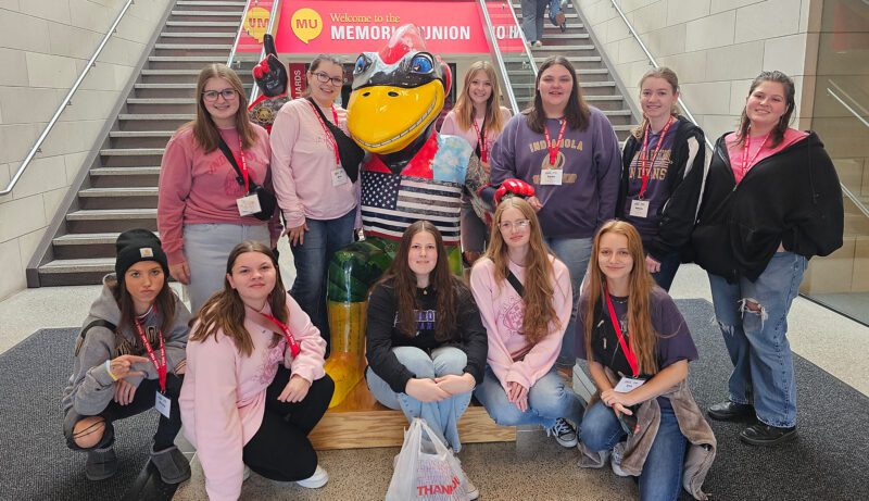 ICT-1 Group of students around Cy statue