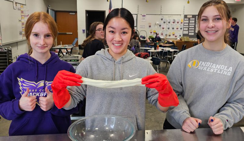 ICT-3 Group of students cooking with one holding dough