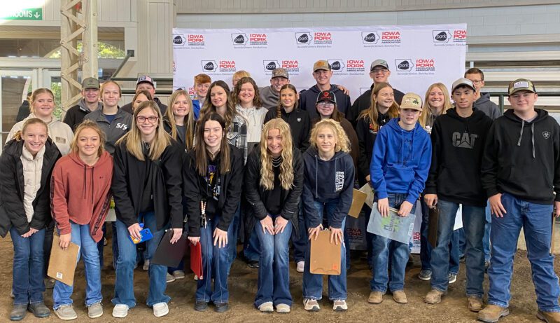 ICT-7 Group of students in front of an Iowa Pork Banner