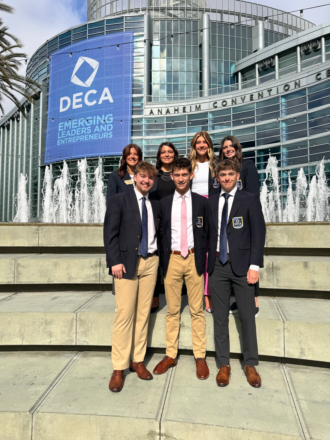 business-deca Group of students in front of the Anaheim Convention Center with DECA sign