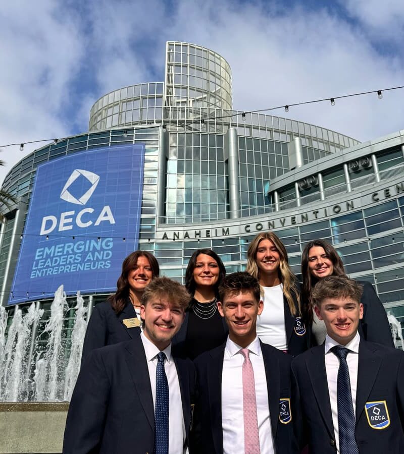Students in front of Anaheim Convention Center with DECA sign